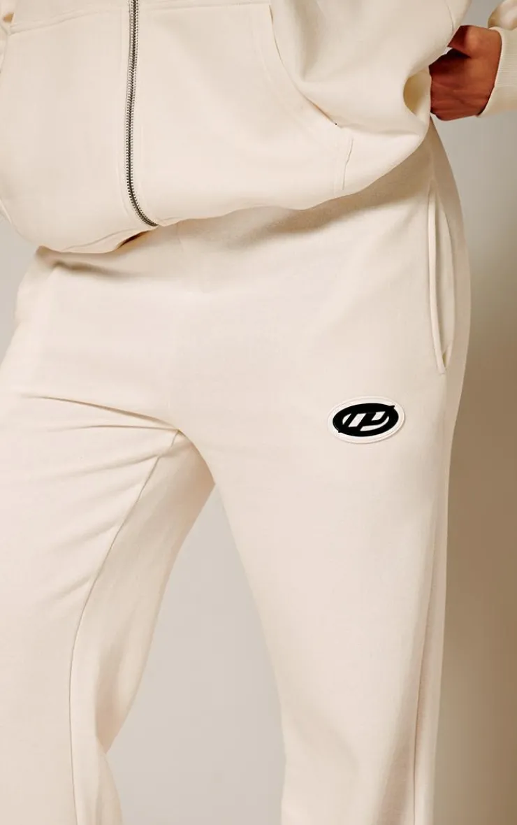 Online PrettyLittleThing Contrast Logo Badge Wide Leg Sweatpants Cream